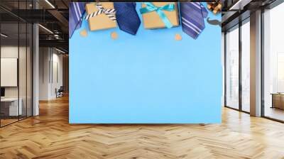 Happy Fathers Day gift tag with long border of ties, gifts and games on a blue banner background. Above view with copy space. Wall mural