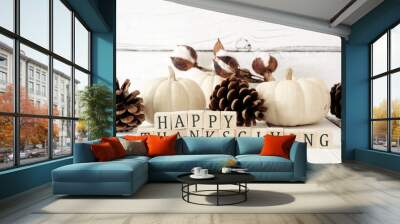 Happy Thanksgiving greeting on wooden blocks against a white wood background with white pumpkins and brown autumn decor Wall mural