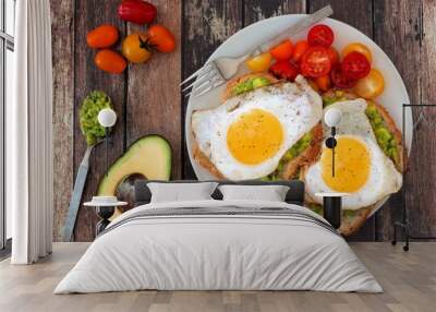 Healthy avocado, egg open sandwiches on a plate with cherry tomatoes on rustic wood Wall mural