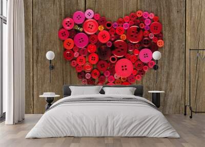 Heart shape of red and pink buttons over wood background Wall mural