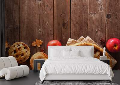 Homemade autumn apple pie bottom border. Above view table scene over a rustic wood background with copy space. Wall mural