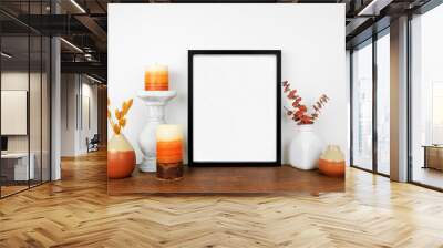 Mock up black frame with fall branches and decor on a wood shelf. Autumn concept. Portrait frame against a white wall. Wall mural