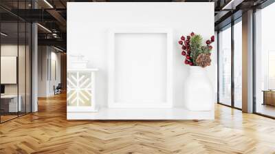 Mock up white frame with Christmas lantern and decor on a shelf. Portrait frame against a white wall. Wall mural