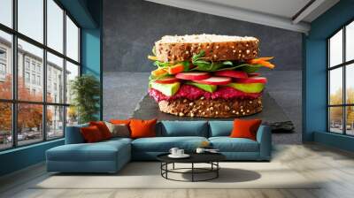 Superfood sandwich with beet hummus, avocado, vegetables and greens, on whole grain bread against a slate background Wall mural