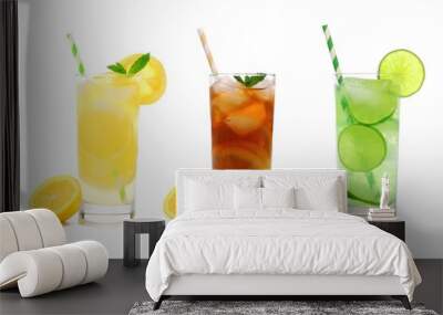 Three glasses of summer lemonade, iced tea, and limeade drinks with straws isolated on a white background Wall mural