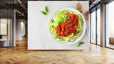 Zucchini pasta topped with meatless walnut cauliflower bolognese. Top view on a white marble background. Healthy eating, plant-based meat substitute concept. Wall mural