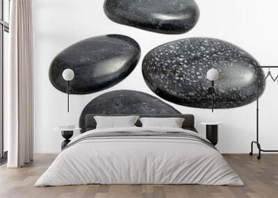 Smooth black spa stones arranged on a white background, perfect for wellness, zen, relaxation, and meditation themes in stock photography. Wall mural