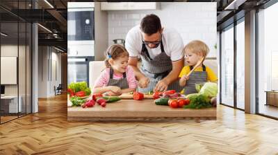   father with children preparing vegetable salad Wall mural