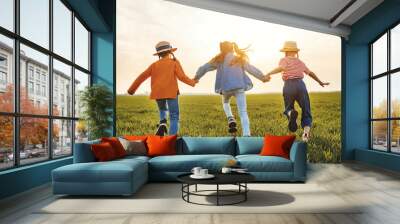 Anonymous happy children running backin field Wall mural