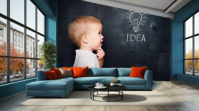 baby child at the blackboard with chalk drawn bulb symbol ideas Wall mural