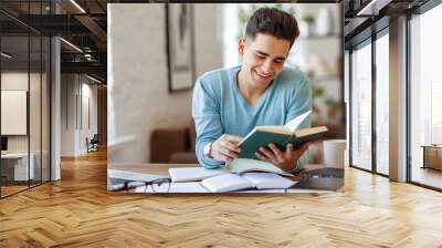 Cheerful ethnic student reading book. Wall mural