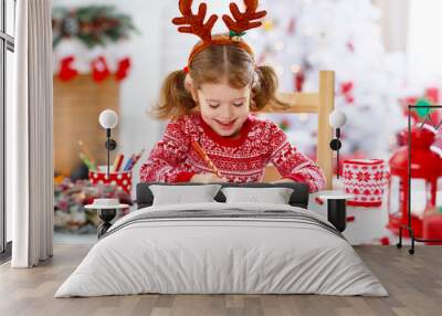 child girl writing letter santa home near Christmas tree Wall mural