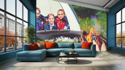 Children's tourism. Happy kids  girls in campaign in tent near fire Wall mural