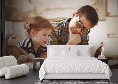 children brother and sister, boy and girl reading a book Wall mural