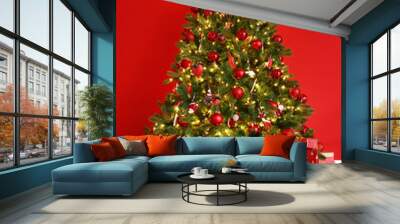 Christmas tree on the background of   red empty wall. Wall mural