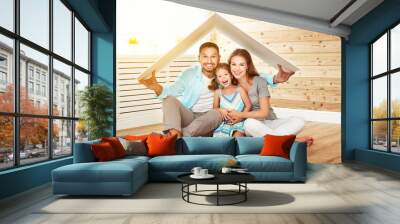 concept housing   young family. Mother father and child in new house with  roof Wall mural