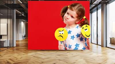 concept of children's emotions. child girl chooses between a sad and joyful smile Wall mural