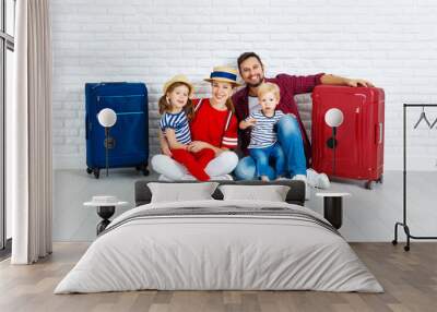 concept travel and tourism. happy family with suitcases near   wall. Wall mural