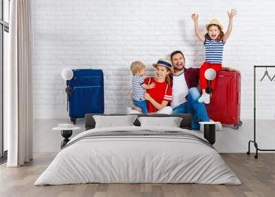 concept travel and tourism. happy family with suitcases near   wall. Wall mural