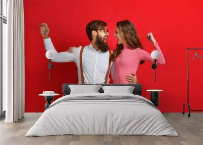 couple of emotional people man and woman on red background. Wall mural