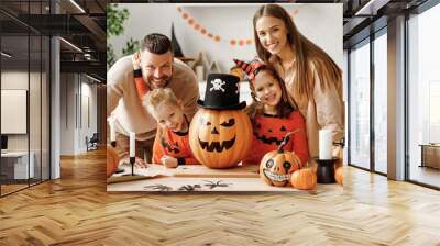 Delighted family during Halloween celebration. Wall mural