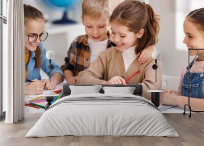 Diligent girl speaking with classmates Wall mural