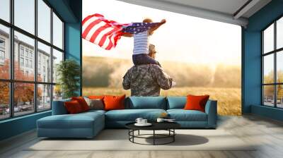 Excited child sitting with american flag on shoulders of father reunited with family Wall mural