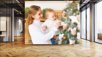 family mother and baby decorate christmas tree Wall mural