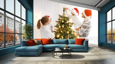 family mother father and children decorating a Christmas tree at home Wall mural