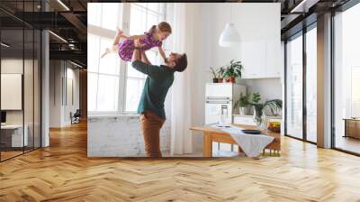 Father's day. Happy family daughter hugs his dad Wall mural