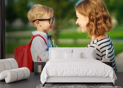 first day at school. mother leads  little child school boy in first grade Wall mural