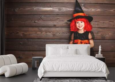 funny child girl in witch costume in halloween. Wall mural