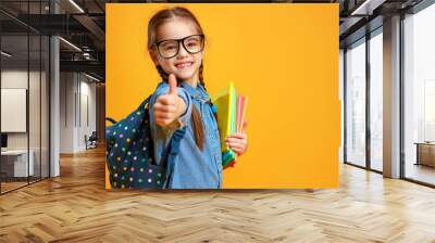 funny child school girl girl on yellow background    . Wall mural