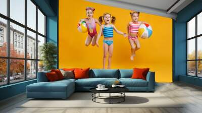 funny funny happy children  jumping in swimsuit  jumping  on colored background. Wall mural