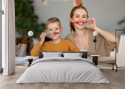 funny mother and child son playing and doing homework writing and reading Wall mural