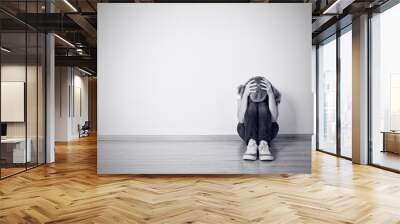 girl sits in a depression on the floor near the wall Wall mural