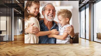 Grandfather hugging grandchildren on sofa. Wall mural