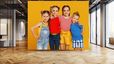 group of cheerful happy children on colored yellow background. Wall mural