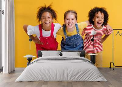 Group of cheerful happy multinational children on  yellow background Wall mural