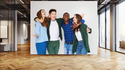 group of cheerful young people men and women isolated on white background. Wall mural