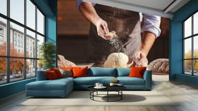 Hands of baker kneading dough Wall mural