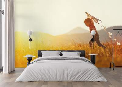 happy child girl with a kite running on meadow in summer Wall mural