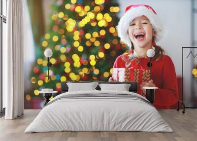 happy child girl with christmas gifts near tree in  morning Wall mural