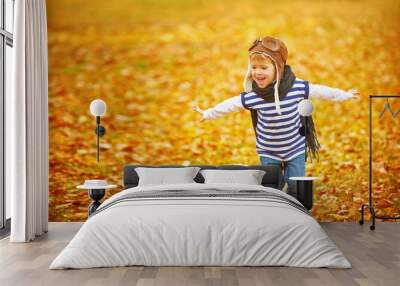 happy child playing pilot aviator outdoors in autumn Wall mural