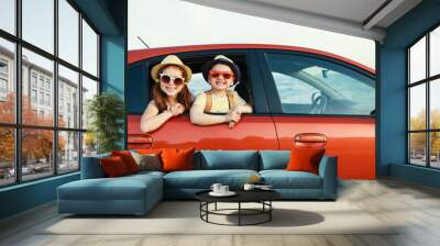 happy children girl and boy goes to summer travel trip in car. Wall mural