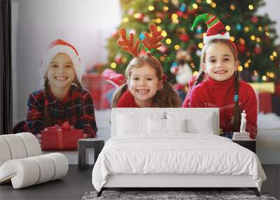 happy children girls with christmas gifts near tree in  morning Wall mural