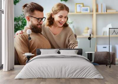 happy couple with laptop computer at home  . Wall mural