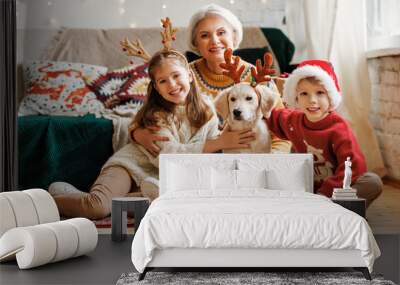 Happy family, grandmother, children and dog golden retriever during Christmas at home Wall mural