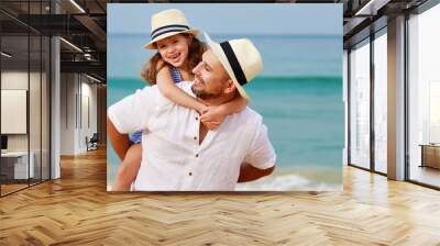 happy family at beach. father and child daughter hug at sea. Wall mural