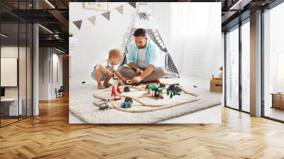 happy family father and child son playing   in toy railway in playroom Wall mural